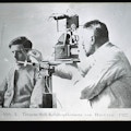 A doctor examining a patient's ear using an elaborate-looking diagnostic tool.