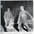 One worker pours babbitt with a single hand ladle while another worker looks on. They both have safety glasses on, which are emphasized by 2 drawn on white arrows.