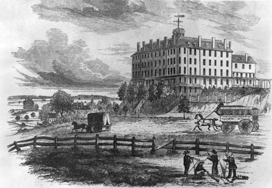 Exterior, corner view of Perkins Institution, with horse-drawn wagons and children with kites.