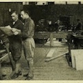 Men working at carpentry machinery.