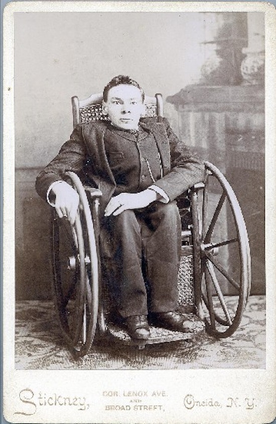 A young man in a wheelchair in a Victorian home.