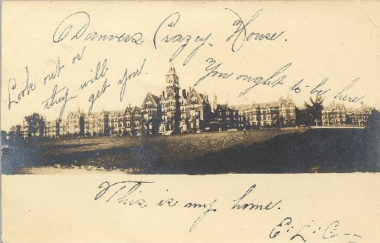 A picture of large insitution buildings with a handwritten message.
