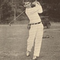 A young man swings a golf club.