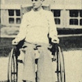 A young man sits in a wheelchair.