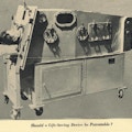 A man lies inside an early respirator machine.