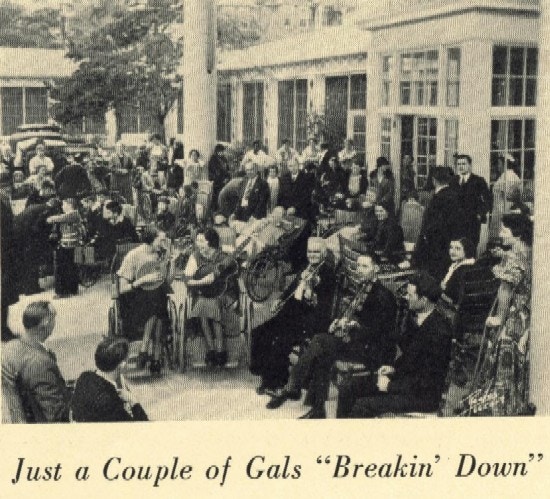 People in a courtyard, many in wheelchairs, playing instruments.