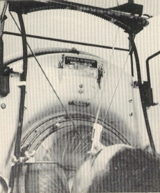 A woman types from an iron lung using her tongue.