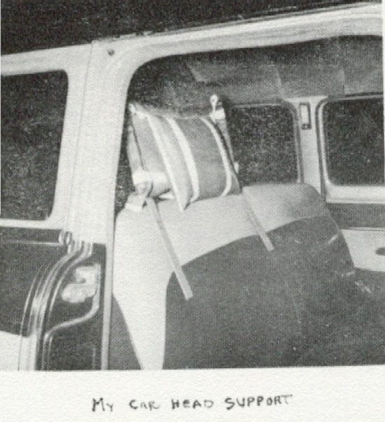A photograph of a car seat with a homemade head support.