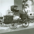 A set of four miniature carriages, one in the shape of a walnut.