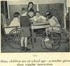 Six children, two in wheelchairs, examine a globe, their teacher in the background.