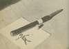 A weapon made of rubber hose laying on a table.