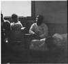 Young men on wooden benches.