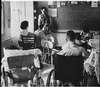 A woman teaches a classroom of children.