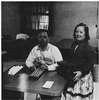 A man and a woman at a table with peg boards.