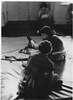 Children sitting on mats.