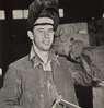 A man wearing a welding shield.