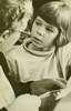 A boy with an elderly woman who holds scissors.