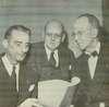 Three leaders of Goodwill Industries examine a report.