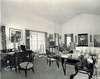 Large room with desk, chairs, and sofa.
