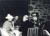King George sits at a table with two women and a man outside Top Cottage.