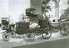 A set of four miniature carriages, one in the shape of a walnut.