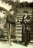 Mrs. Coolidge presents a medal to a man (L.B. Clark) on crutches.