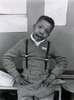 Photograph of a young African-American boy in a sweater and suspenders.