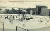 Postcard photograph of children playing in a pool.