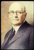 Portrait of Edgar Fiske Allen -- well-dressed man; mustachioed, glasses, balding.