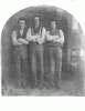 Three men stand with their arms folded across their chests.