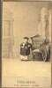 Chinese man of small stature stands with one arm on a chair.