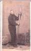 An African-American man in a fur suit holds an oar.