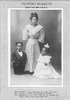 An average-sized Filipino woman stands next to two short-statured Filipinos.