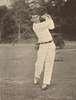 A young man swings a golf club.