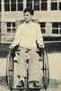 A young man sits in a wheelchair.