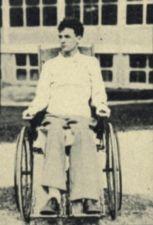 A young man sits in a wheelchair.
