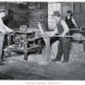 Three men working in a dowel shop.
