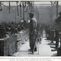 Two men working in wire drawing factory.