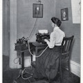 Woman sitting at a typewriter taking dictation.