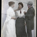 Helen Keller in lightly colored long dress, (left) Anne Sullivan in collard shirt and skirt, (center) and Jefferson in dark suit with goatee (right).