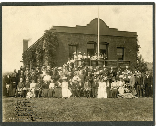 Group photograph in front of brick building.