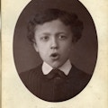 Photograph flashcard of a young boy demonstrating phonetic sounds by mouth movement.