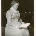 Srah Fuller seated, reading.