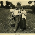 Man and woman walking in field.