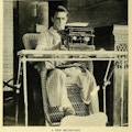 One-legged man sits at typewrite