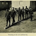 Six men walking on a beam.