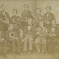Perkins students, boys in suits, with band instruments.
