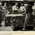 Six men, some amputees, in woodworking shop.