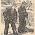 Two boys shovel snow on a street.