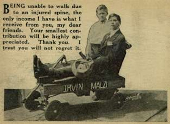 Photograph of young man sitting in a wagon with boy standing behind him